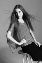 Young beautiful smiling stylish woman sitting chair