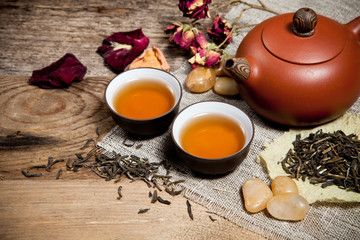 Tea cups with teapot on old wooden table