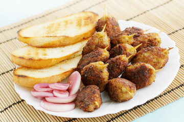 lula kebab with croutons and pickled onions