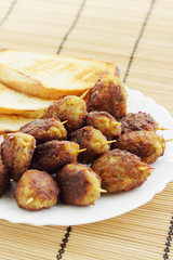 lula kebab with croutons and pickled onions