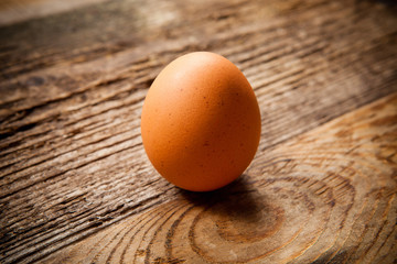 Single egg on wooden table