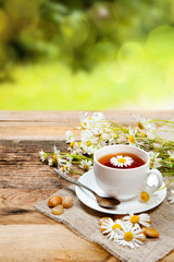 herbal tea with chamomile on old wooden table