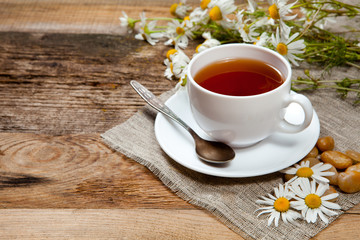 herbal tea with chamomile on old wooden table