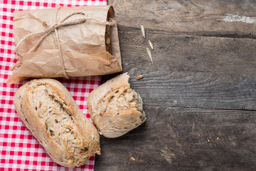 Traditional bread on old wooden table with red cloth 