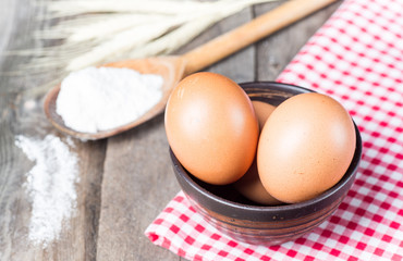 The flour and eggs on kitchen table