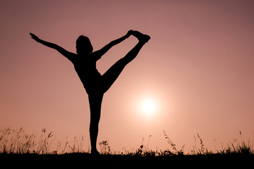 Silhouette woman with standing position yoga.