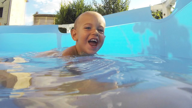 Little Child Playing in the Swimming Pool