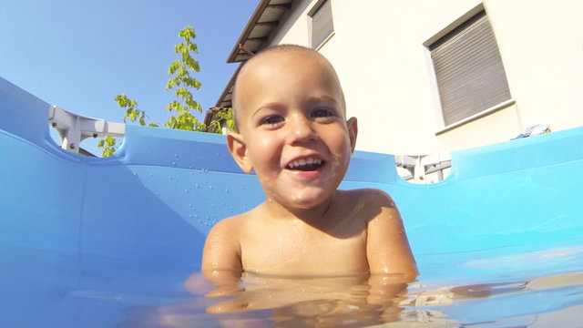 Little Child Playing in the Swimming Pool