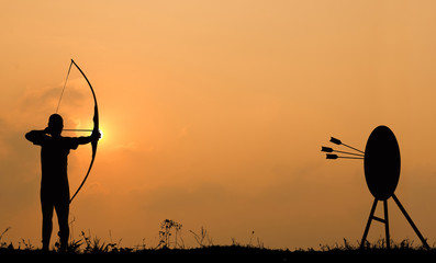 Silhouette archery shoots a bow at the target. - obrazy, fototapety, plakaty