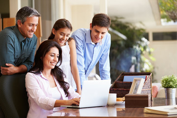 Fototapeta premium Family Looking At Laptop Together