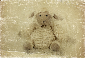 Cute sheep toy. Grunge effect.