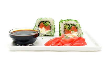 rolls with cucumber, salmon and cream cheese on a plate - white