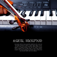 Violin and piano keys on black