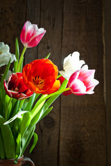 Tulip flowers in wooden background