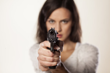 angry girl aiming a gun at you