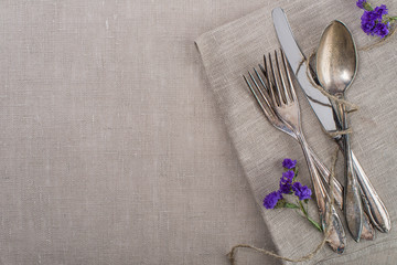 Vintage silverware with flowers on grey background