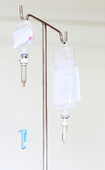 Infusion bottle with IV solution on white background