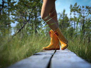 Sexy young lady's legs wearing rain boots