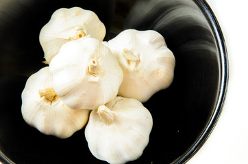 Garlic in the cup on white background