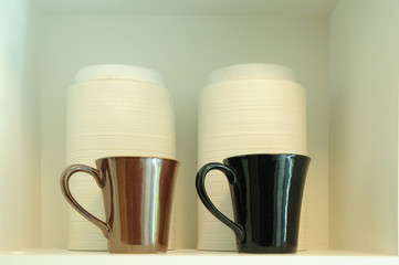 Double coffee-cups on white shelf