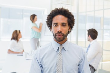 Serious businessman with colleagues in meeting