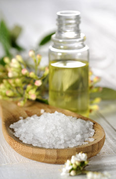 sea salt and spa oil on a wooden table close up
