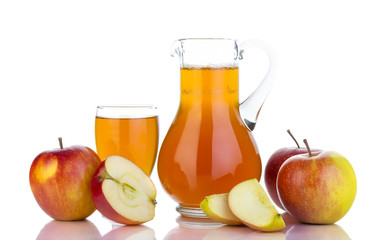 Fresh apples, glass with juice and carafe