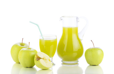 Fototapeta na wymiar Fresh green apples, glass with juice and carafe