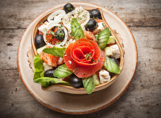 Fresh vegetable salad on wooden table