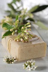 natural soap with flower on a wooden table
