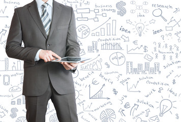 Man in suit holding tablet pc