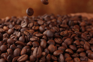 Coffee beans on table on brown background