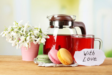 Tasty herbal tea and cookies on wooden table