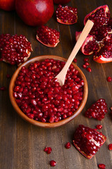 Ripe pomegranates on table close-up