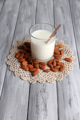 Almond milk in jug with almonds in bowl,