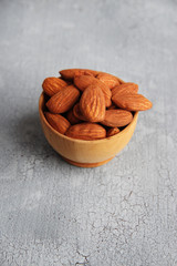 Almonds on color wooden background