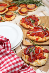 Small pizzas on baking paper close up