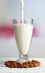 Almond milk is poured into glass,