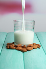 Almond milk is poured into glass,