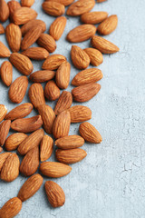 Almonds on color wooden background