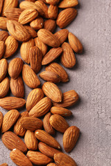 Almonds on color wooden background