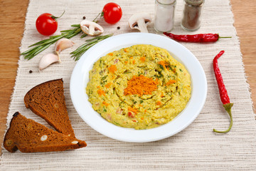 Bowl of tasty fresh hummus, close up
