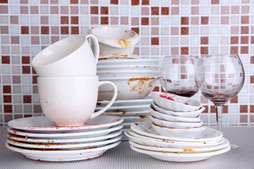 Dirty dishes on bright background