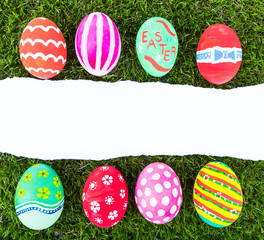 Easter Eggs and  ripped paper on Fresh Green Grass