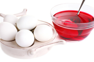 Eggs with liquid colour in glass bowl isolated on white