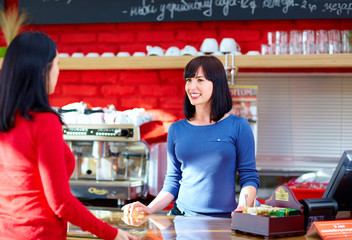 waitress serves customer in coffee shop