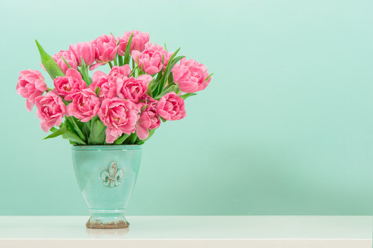 Fototapeta pastel pink tulip flowers over turquoise