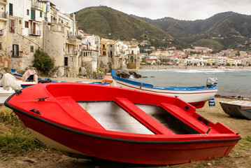 Fototapeta premium Sicilian fishing boat on the beach in Cefalu, Sicily