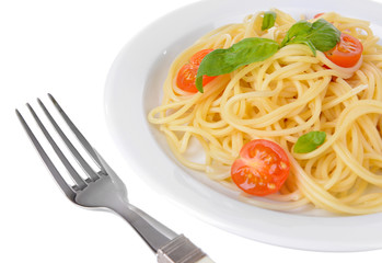 Delicious spaghetti with tomatoes on plate close-up