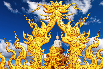 Buddha statue against a blue sky with clouds. Chiang Rai.